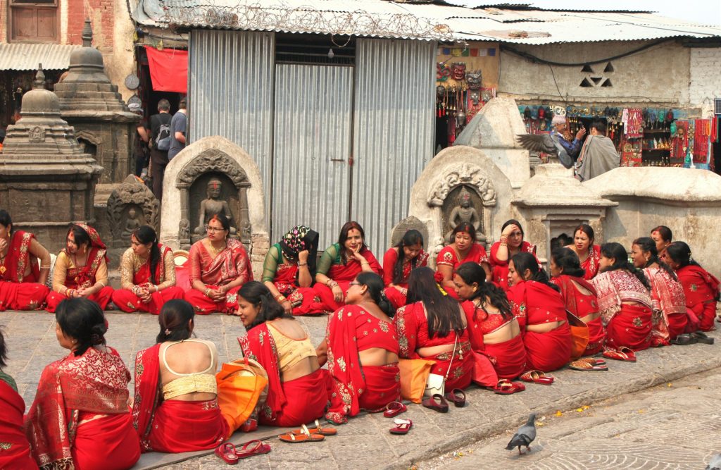 Group of Nepalese married women wearing red colored tradition attire gathered to celebrate Teej Festival